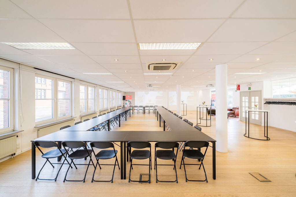 Large bright conference room with black chairs