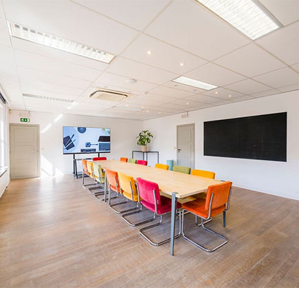 large meeting room with big tv screen and big table