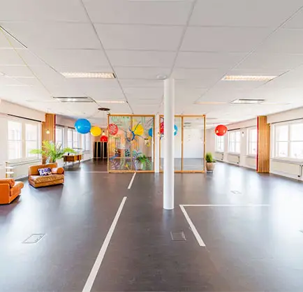 large room with colorful balloons in the back