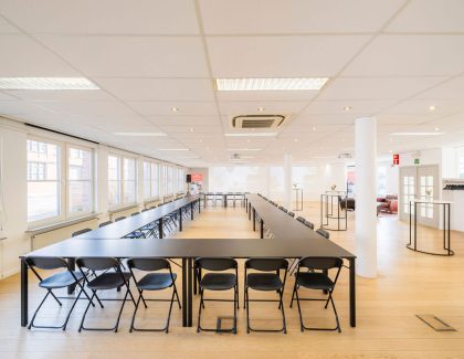 Large bright conference room with black chairs