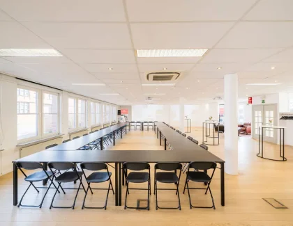Large bright conference room with black chairs