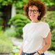 white woman with white tee-shirt hands in trousers pockets